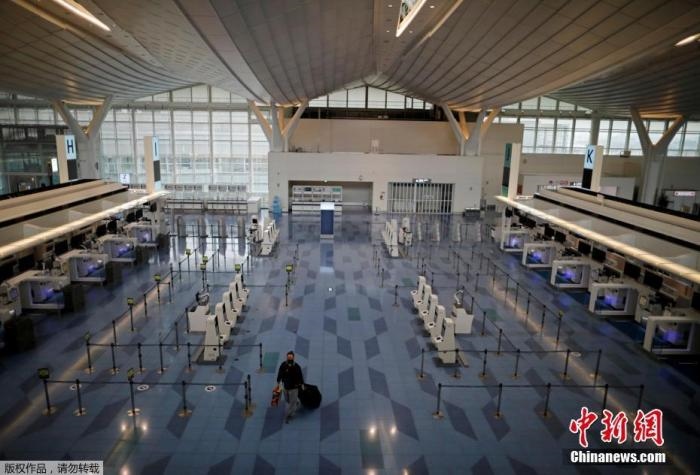 資料圖：日本東京，東京國際機場，一名乘客在國際航班航站樓的登機區(qū)。