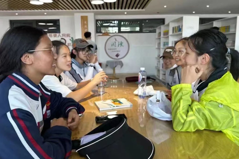 2023年7月10日，在果洛西寧民族中學(xué)，上海市大同中學(xué)學(xué)生（右）與果洛西寧民族中學(xué)學(xué)生交流。新華社發(fā)（果洛州教育局供圖）