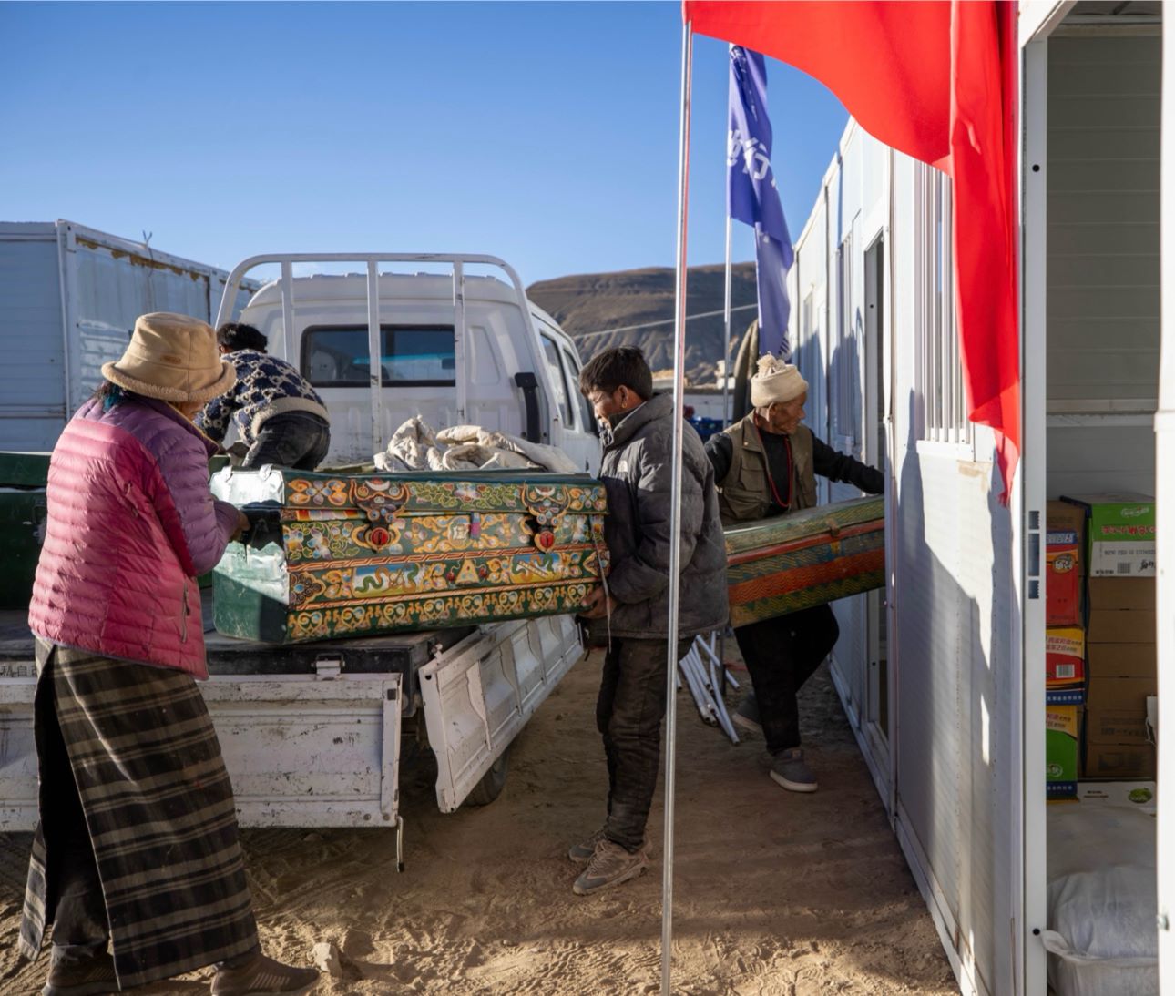 1月11日，西藏定日縣曲洛鄉(xiāng)措昂村，首批入住活動板房的村民正在搬運物品，為入住做準備。人民日報記者張武軍攝