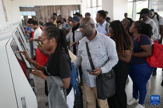 5月31日，在蒙內(nèi)鐵路內(nèi)羅畢站，乘客在自助取票機前排隊取票。新華社記者 楊光 攝