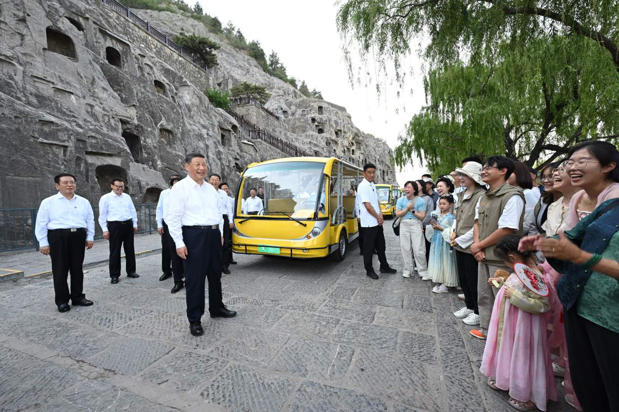 5月19日，習(xí)近平在洛陽龍門石窟考察時(shí)，同游客親切交流。