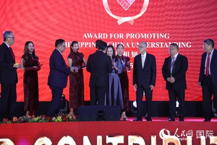 黃溪連大使給榮獲“重要貢獻獎”的奎松市市長喬伊·貝蒙蒂等人頒獎。人民網(wǎng)記者 樊帆攝